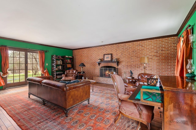 home office featuring crown molding, brick wall, a brick fireplace, and wood finished floors