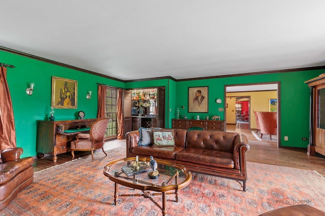 living area featuring ornamental molding and wood finished floors