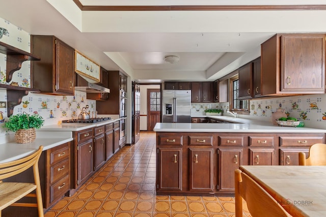 kitchen featuring light countertops, open shelves, appliances with stainless steel finishes, and a tray ceiling