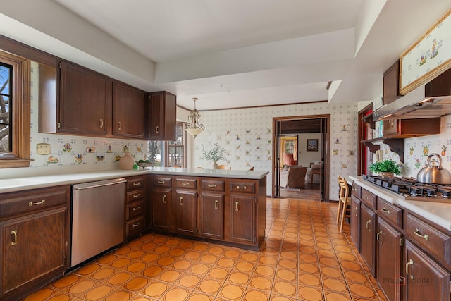 kitchen with gas cooktop, dishwasher, light countertops, a peninsula, and wallpapered walls