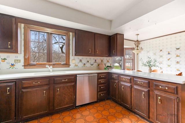 kitchen featuring dishwasher, a sink, light countertops, a peninsula, and wallpapered walls