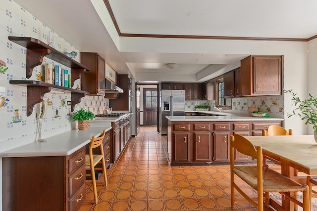 kitchen featuring light countertops, open shelves, appliances with stainless steel finishes, and backsplash