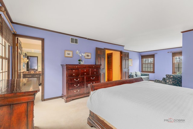 bedroom with baseboards, ornamental molding, light carpet, and visible vents