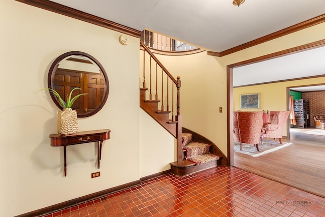 stairs featuring crown molding and baseboards
