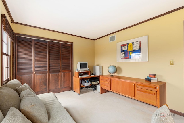 home office with visible vents, ornamental molding, baseboards, and light carpet