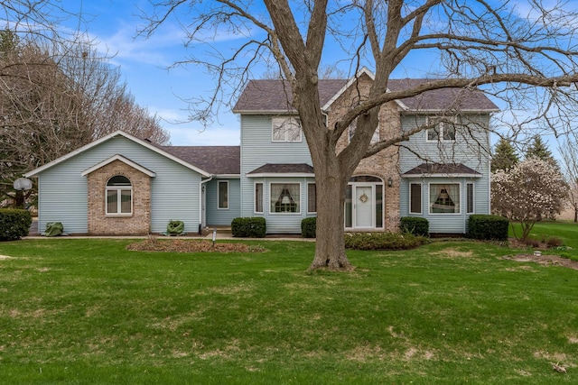 17 Thistle Trl, Caledonia, IL 61011 - traditional-style home featuring brick siding, a front yard, and a shingled roof