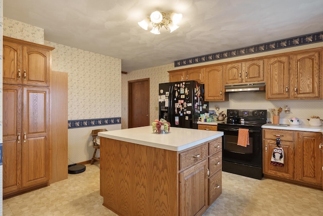 17 Thistle Trl, Caledonia, IL 61011 - kitchen with black appliances, under cabinet range hood, light flooring, wallpapered walls, and light countertops