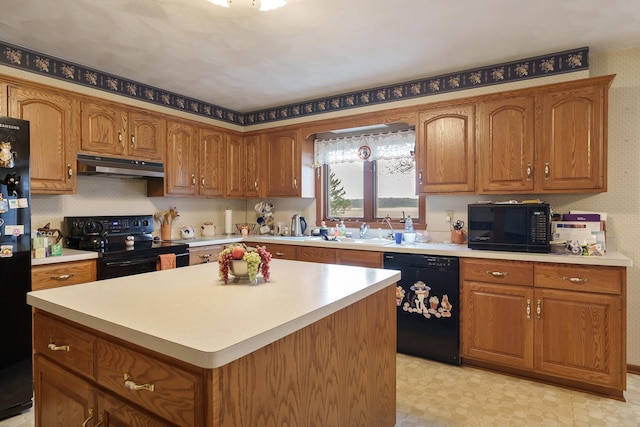17 Thistle Trl, Caledonia, IL 61011 - kitchen with black appliances, under cabinet range hood, and brown cabinets