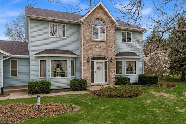 17 Thistle Trl, Caledonia, IL 61011 - traditional-style house featuring a front lawn, a shingled roof, and brick siding