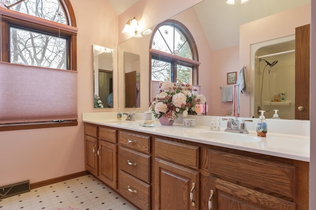 17 Thistle Trl, Caledonia, IL 61011 - bathroom with tile patterned floors, double vanity, a shower, and high vaulted ceiling