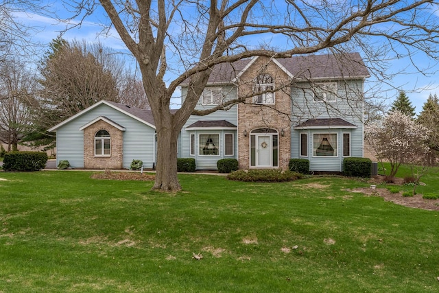 17 Thistle Trl, Caledonia, IL 61011 - view of front facade featuring a front lawn, brick siding, and a shingled roof