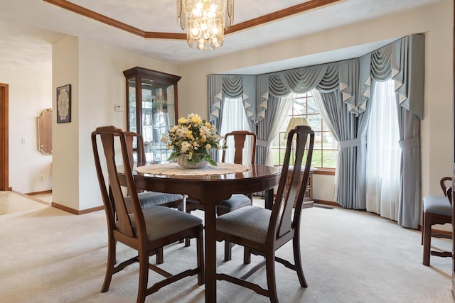 17 Thistle Trl, Caledonia, IL 61011 - dining space with light colored carpet, a chandelier, a raised ceiling, and crown molding