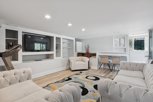 living room with recessed lighting, baseboards, visible vents, and light wood-style floors