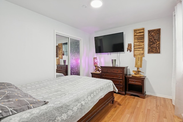 bedroom with baseboards and light wood-type flooring