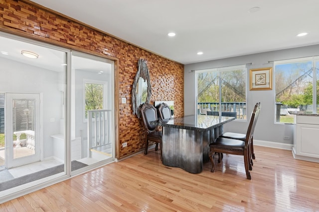 dining room with recessed lighting, baseboards, and light wood finished floors