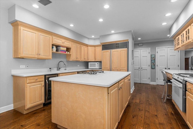 441 Oakland Dr, Highland Park, IL 60035 - kitchen featuring white appliances, a sink, light brown cabinetry, a center island, and baseboards