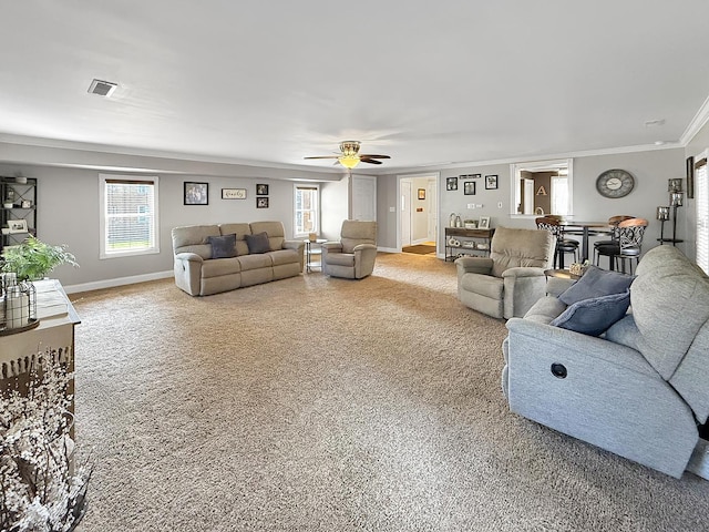 1402 W Lincoln Blvd, Freeport, IL 61032 - living area featuring ornamental molding, light colored carpet, ceiling fan, and plenty of natural light