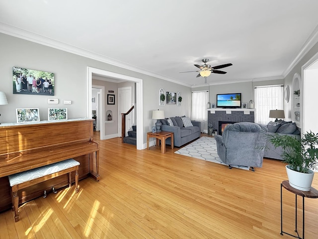 1402 W Lincoln Blvd, Freeport, IL 61032 - living area with light wood finished floors, stairway, ceiling fan, crown molding, and a brick fireplace