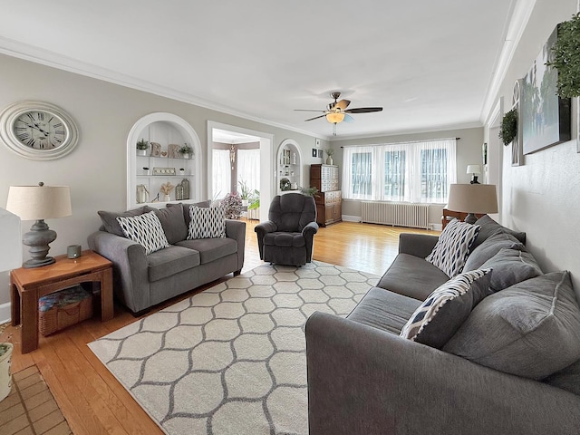 1402 W Lincoln Blvd, Freeport, IL 61032 - living area with radiator heating unit, ornamental molding, light wood-style floors, ceiling fan, and built in features