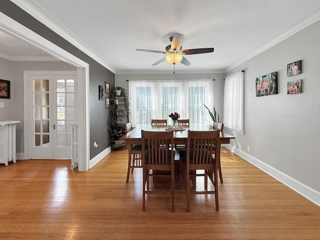 1402 W Lincoln Blvd, Freeport, IL 61032 - dining space with a ceiling fan, light wood-style flooring, ornamental molding, and radiator