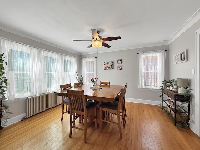 1402 W Lincoln Blvd, Freeport, IL 61032 - dining area featuring radiator heating unit, a ceiling fan, light wood finished floors, and crown molding