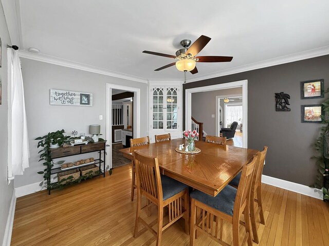 1402 W Lincoln Blvd, Freeport, IL 61032 - dining area with ceiling fan, light wood-style floors, and crown molding