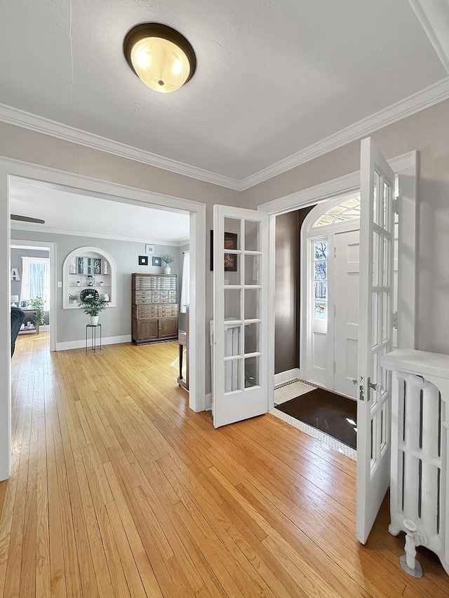 1402 W Lincoln Blvd, Freeport, IL 61032 - foyer entrance with light wood-style floors, ornamental molding, and radiator