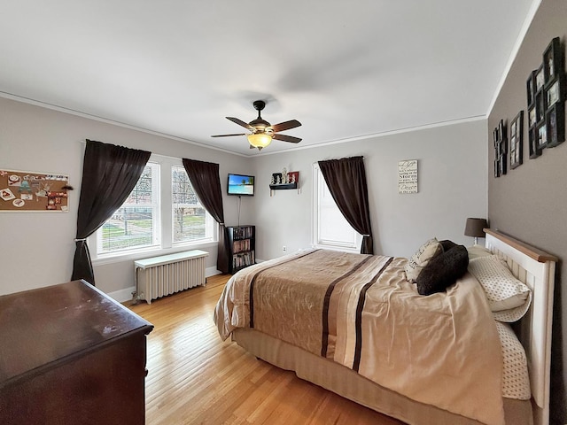 1402 W Lincoln Blvd, Freeport, IL 61032 - bedroom with radiator heating unit, light wood finished floors, ornamental molding, and ceiling fan