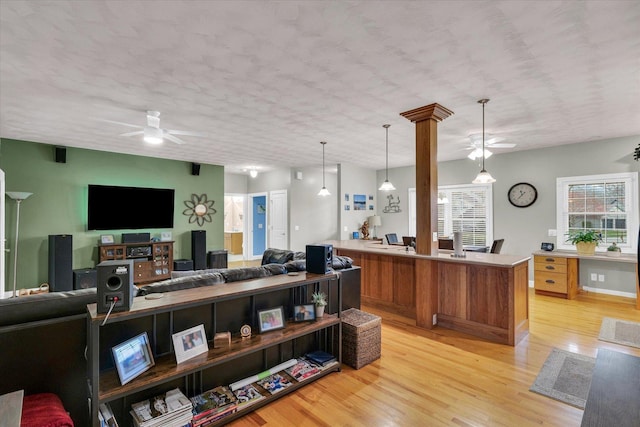 living area featuring a ceiling fan and light wood finished floors