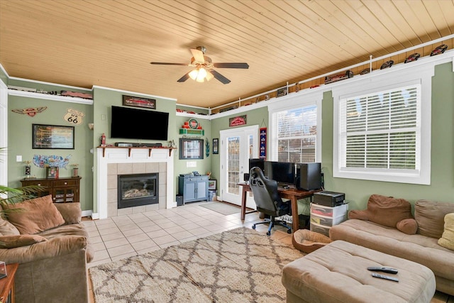 tiled living area featuring french doors, wooden ceiling, a ceiling fan, and a tile fireplace