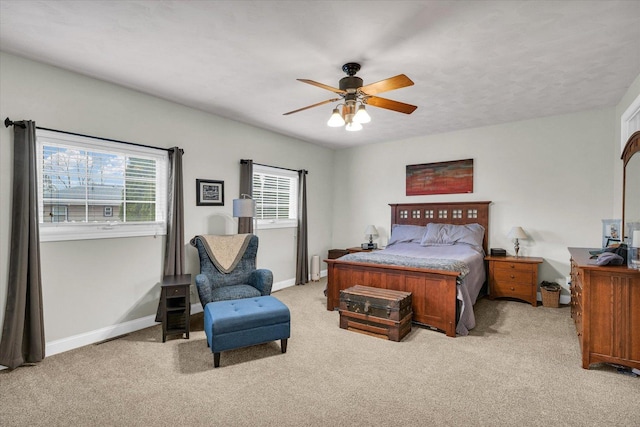 bedroom featuring baseboards and light carpet