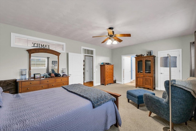 bedroom with light colored carpet, baseboards, and ceiling fan