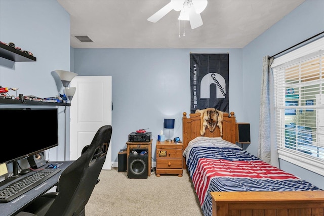 carpeted bedroom with ceiling fan and visible vents