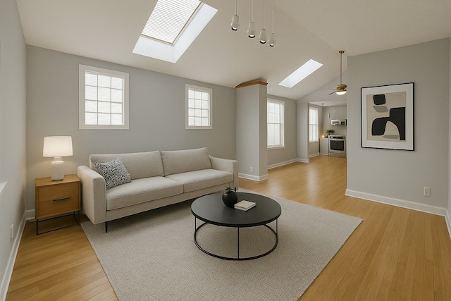 3114 N Long Ave, Chicago, IL 60641 - living area with vaulted ceiling with skylight, baseboards, and light wood finished floors