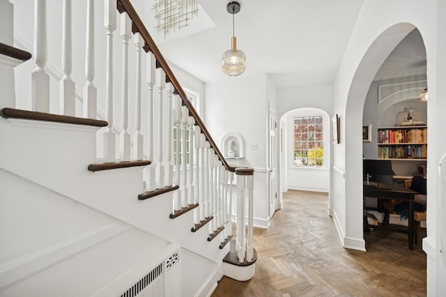 420 Washington Ave, Glencoe, IL 60022 - entryway featuring stairs, arched walkways, baseboards, and radiator heating unit