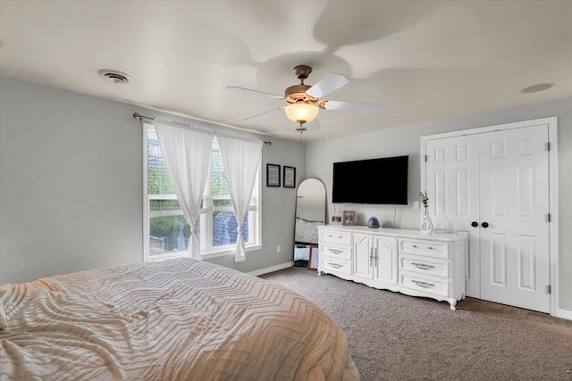 carpeted bedroom featuring baseboards, a ceiling fan, and visible vents