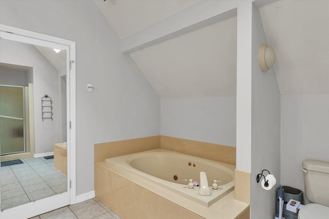 bathroom with tile patterned flooring, toilet, a tub with jets, a shower stall, and vaulted ceiling