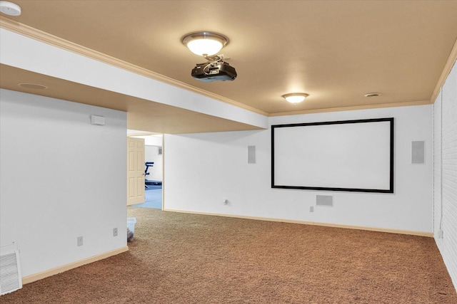 home theater featuring crown molding, carpet flooring, baseboards, and visible vents