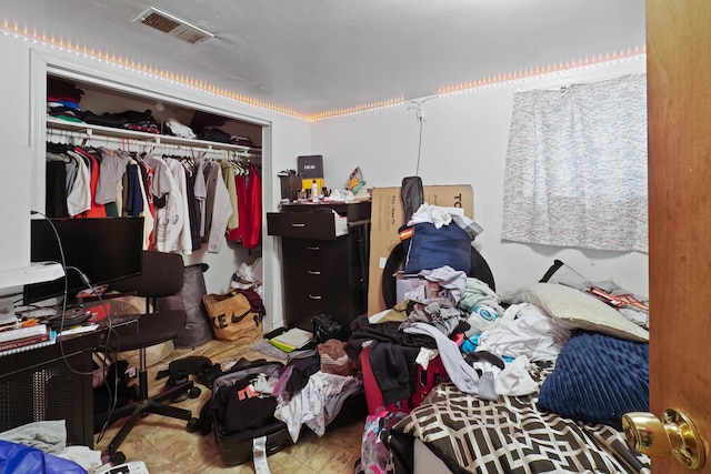bedroom with visible vents and a closet