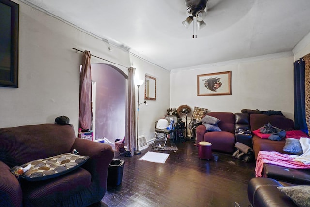 living room featuring visible vents, a ceiling fan, hardwood / wood-style flooring, and ornamental molding