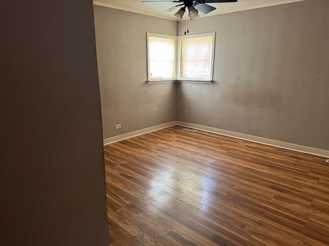 481 Talala St, Park Forest, IL 60466 - spare room featuring ceiling fan, crown molding, dark wood finished floors, and baseboards