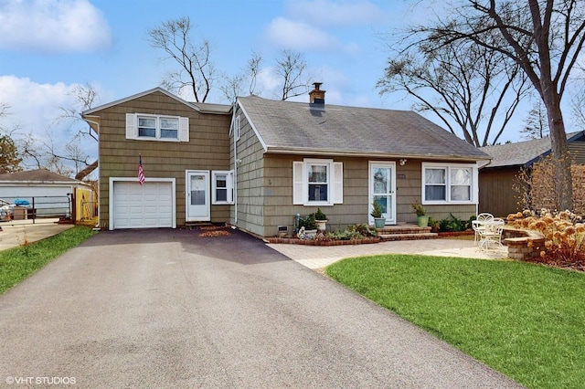 view of front of home featuring a front lawn, a chimney, a shingled roof, an attached garage, and driveway