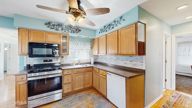kitchen with decorative backsplash, black microwave, white dishwasher, stainless steel range with gas cooktop, and light wood-type flooring