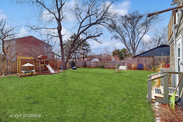 view of yard featuring a fenced backyard and a playground