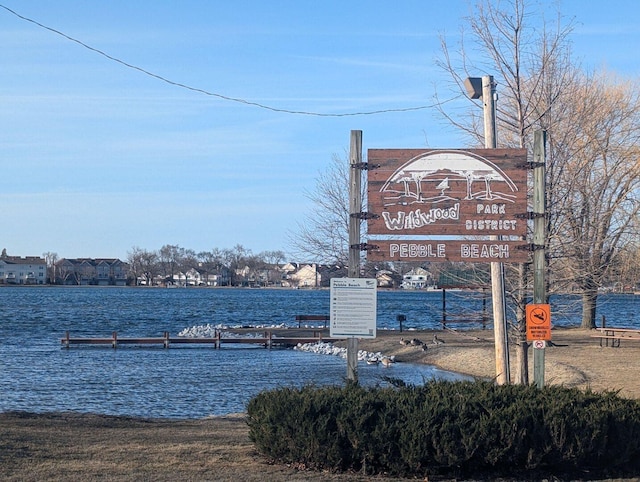 community sign featuring a water view