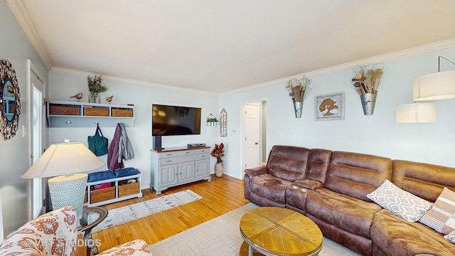 living room with baseboards, ornamental molding, and wood finished floors