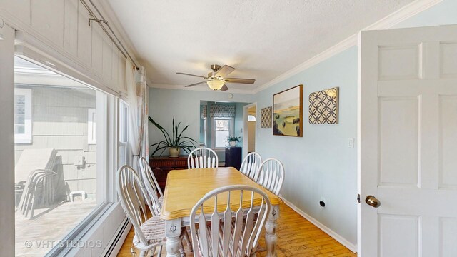 dining space with light wood-style floors, a textured ceiling, a ceiling fan, baseboards, and ornamental molding