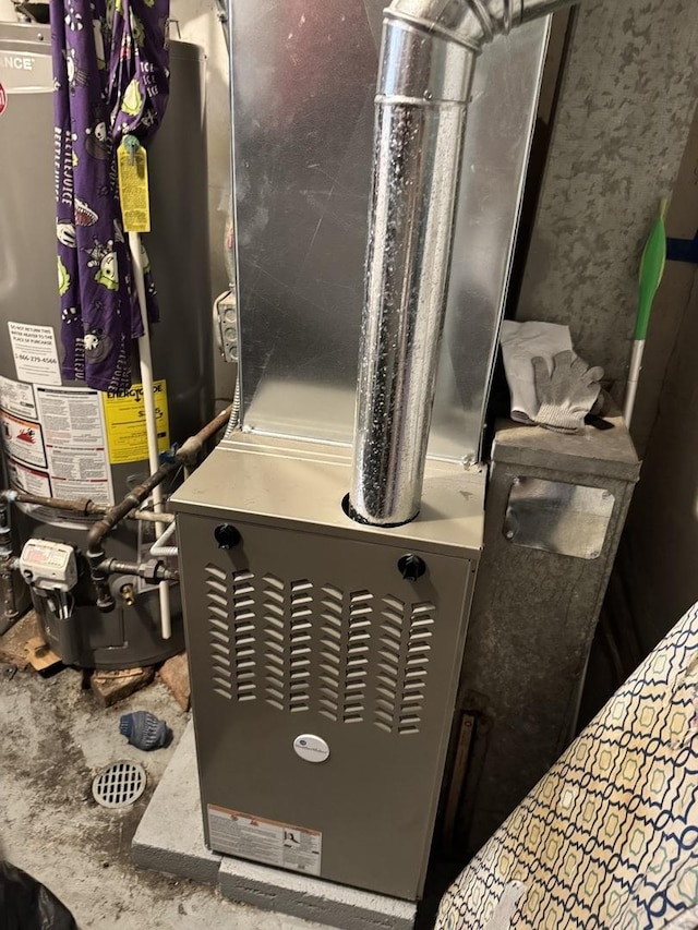 utility room with heating unit and gas water heater