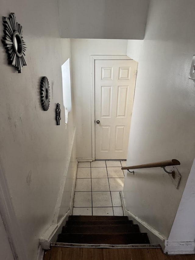 stairway featuring tile patterned floors