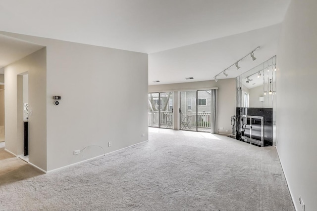 1608 Pennsbury Ct Unit A2, Wheeling, IL 60090 - unfurnished living room featuring carpet flooring, rail lighting, and baseboards